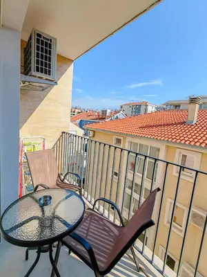 a patio with a table and chairs on a balcony at Modern City Apartment Budva3-Central Location,5 min to Beach in Kravlja