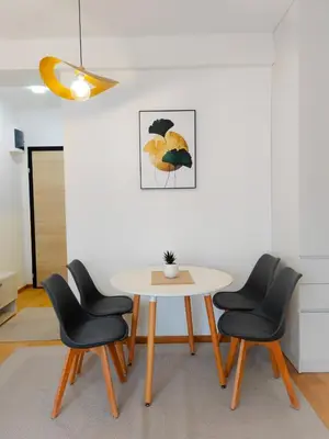 a dining room with a table and four chairs at Modern City Apartment Budva3-Central Location,5 min to Beach in Kravlja