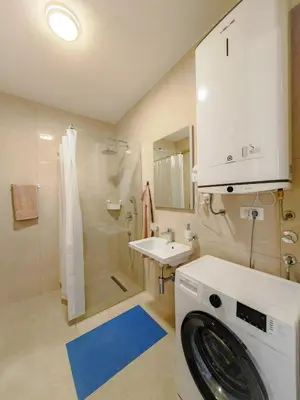 a bathroom with a washing machine and a sink at Modern City Apartment Budva 4-Central Location,5 min to Beach in Budva