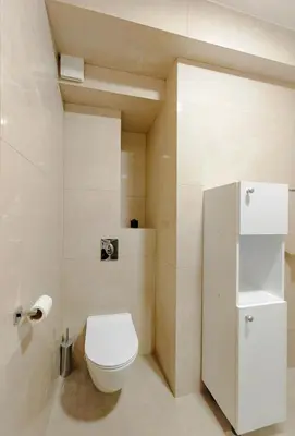 a small bathroom with a toilet and a refrigerator at Modern City Apartment Budva 4-Central Location,5 min to Beach in Budva