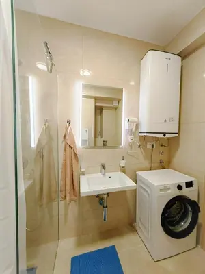 a bathroom with a sink and a washing machine at Modern City Apartment Budva 4-Central Location,5 min to Beach in Budva