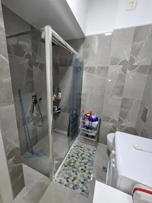 a shower with a glass door in a bathroom at Апартаменты Дельмар in Becici