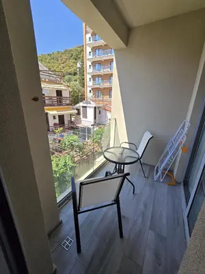a table and chairs on a balcony with a view at Апартаменты Дельмар in Becici