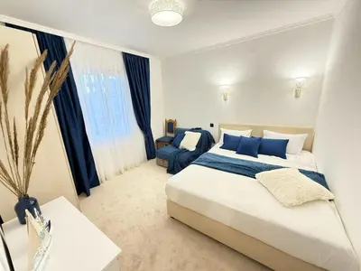 a bedroom with a large bed and a couch at Aurora Apartment in Petrovac na Moru