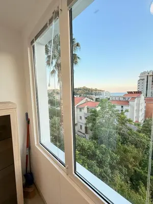 a window with a view of a city at Aurora Apartment in Petrovac na Moru