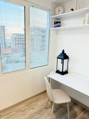 a room with a desk and a chair and a clock at Aurora Apartment in Petrovac na Moru