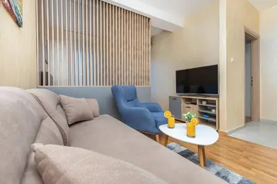 a living room with a couch and a tv at Princess Milena Apartments - Apartment Milena in Becici