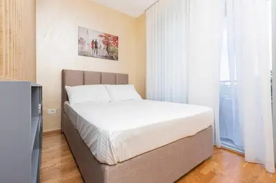 a bedroom with a bed and a television at Princess Milena Apartments - Apartment Milena in Becici