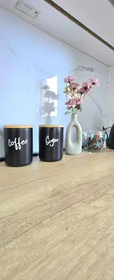 three black drums sitting on a table with a vase with flowers at Apartment Nemanja by Princess Milena in Becici