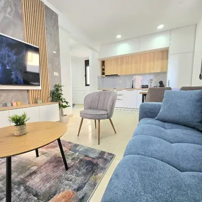 a living room with a blue couch and a table at Apartment Nemanja by Princess Milena in Becici
