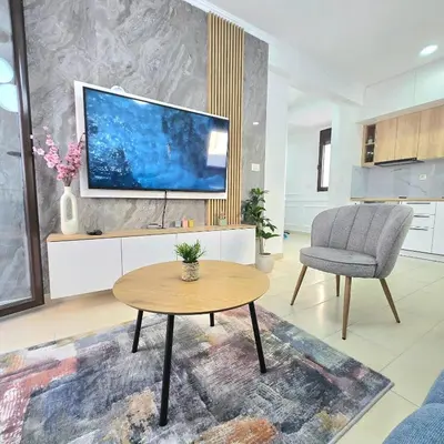 a living room with a tv and a table and a chair at Apartment Nemanja by Princess Milena in Becici