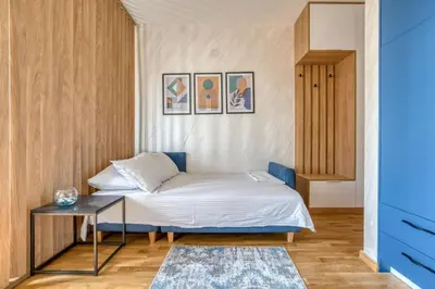 a small bedroom with a bed and a table at Princess Milena Apartments - Studio Balsa in Becici