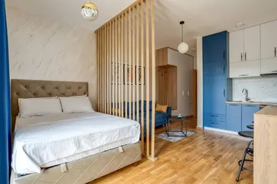 a bedroom with a bed in a room with blue cabinets at Princess Milena Apartments - Studio Balsa in Becici
