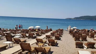 a bunch of chairs and people on a beach at Princess Milena Apartments - Studio Balsa in Becici