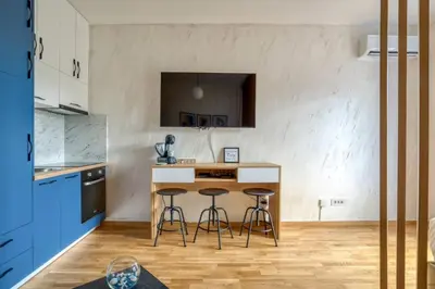 a kitchen with two bar stools and a counter at Princess Milena Apartments - Studio Balsa in Becici