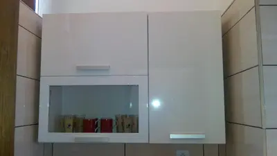 a white cabinet with a window with books in it at Apartments Peranovic in Kotor