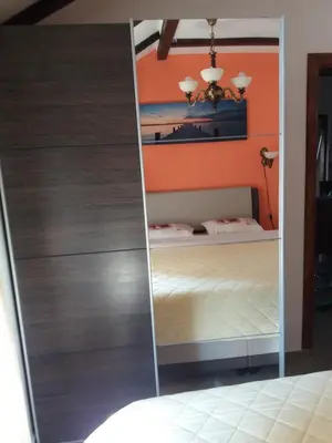 a mirror in a bedroom with a bed at Apartments Peranovic in Kotor