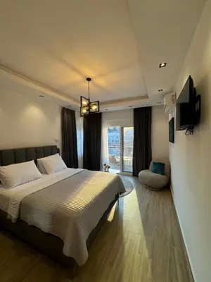 a bedroom with a large bed and a television at gadina inn in Ulcinj