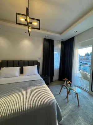a bedroom with a bed and a glass table at gadina inn in Ulcinj