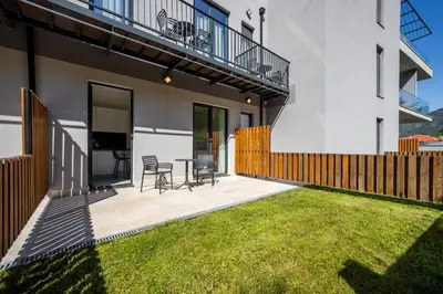 a patio with chairs and a table in a house at Nomio in Tivat