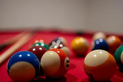 a group of billiard balls on a pool table at Nomio in Tivat