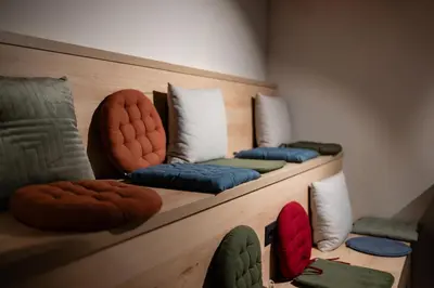 a row of pillows sitting on a wooden shelf at Nomio in Tivat