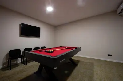 a room with a pool table and a flat screen tv at Nomio in Tivat