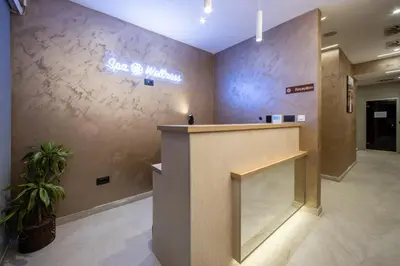 a lobby with a counter and a sign on the wall at Nomio in Tivat