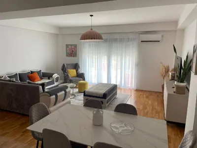 a living room with a table and a couch at Viktorija Apartment Petrovac in Petrovac na Moru