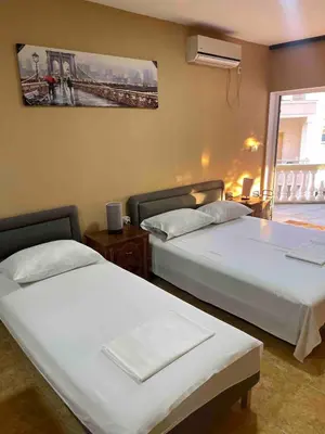 a bedroom with two beds and a window at Fontana Apartments 1A in Ulcinj