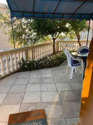 a patio with two chairs and a table and a fence at Fontana Apartments 1A in Ulcinj