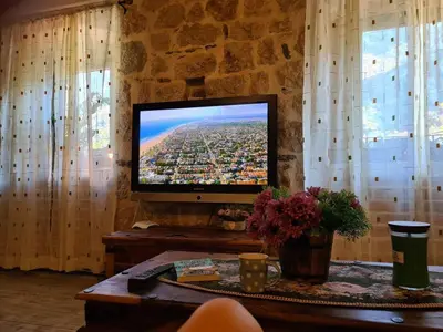 a flat screen tv sitting on top of a table at Charming 3 Bedroom House in Skaljari Montenegro with Garden View in Škaljari