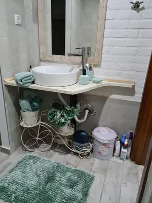 a bathroom with a sink and a mirror at Charming 3 Bedroom House in Skaljari Montenegro with Garden View in Škaljari