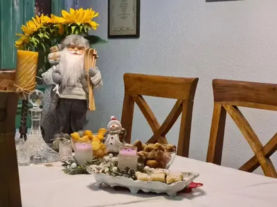 a table with a statue of a man holding a pizza at Charming 3 Bedroom House in Skaljari Montenegro with Garden View in Škaljari