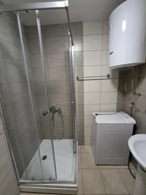 a bathroom with a shower and a toilet and a sink at Apartment tuski put in Podgorica