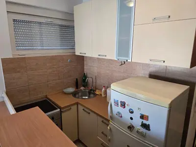 a kitchen with a white refrigerator and a sink at Apartment tuski put in Podgorica