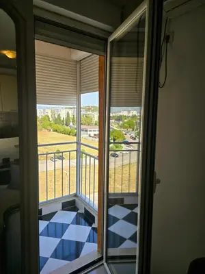 a room with a balcony with a view at Apartment tuski put in Podgorica