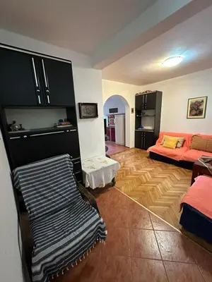 a living room with a couch and a bed at Peaceful family apartment in Budva in Budva