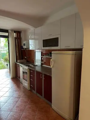 a kitchen with white cabinets and a refrigerator at Peaceful family apartment in Budva in Budva