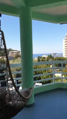 a hammock on a balcony with a view of the ocean at Bojana PLUS - Sea View in Petrovac na Moru