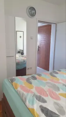 a bedroom with a bed with a colorful comforter at Bojana PLUS - Sea View in Petrovac na Moru
