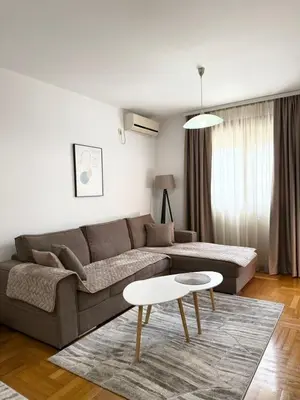 a living room with a couch and a table at Top Apartments Vuković in Podgorica