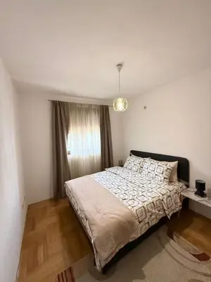 a bedroom with a bed and a window at Top Apartments Vuković in Podgorica