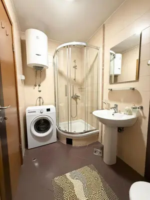 a bathroom with a washing machine and a sink at Top Apartments Vuković in Podgorica