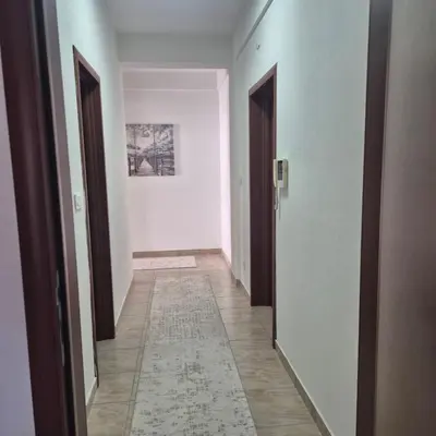 an empty hallway with two doors and a rug at Apartment Suka in Ulcinj