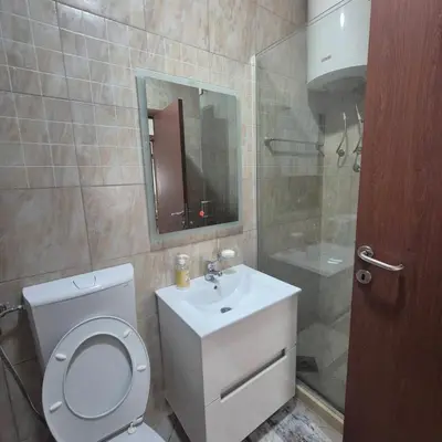 a bathroom with a toilet and a sink and a shower at Apartment Suka in Ulcinj