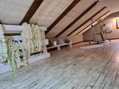 a room with white flowers on a wooden floor at Cheerful three bedroms house with free parking in Kotor