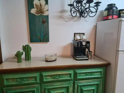 a kitchen counter with a camera and a refrigerator at Cheerful three bedroms house with free parking in Kotor