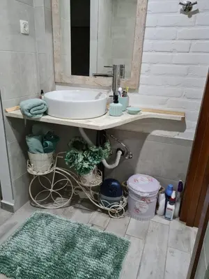 a bathroom with a sink and a mirror at Cheerful three bedroms house with free parking in Kotor