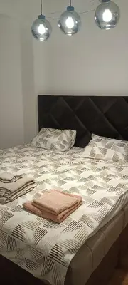 a bed with two towels on top of it at Harmony in Bar